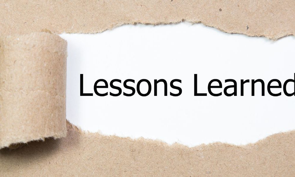 A piece of paper ripped back to expose the words "Lessons Learned."