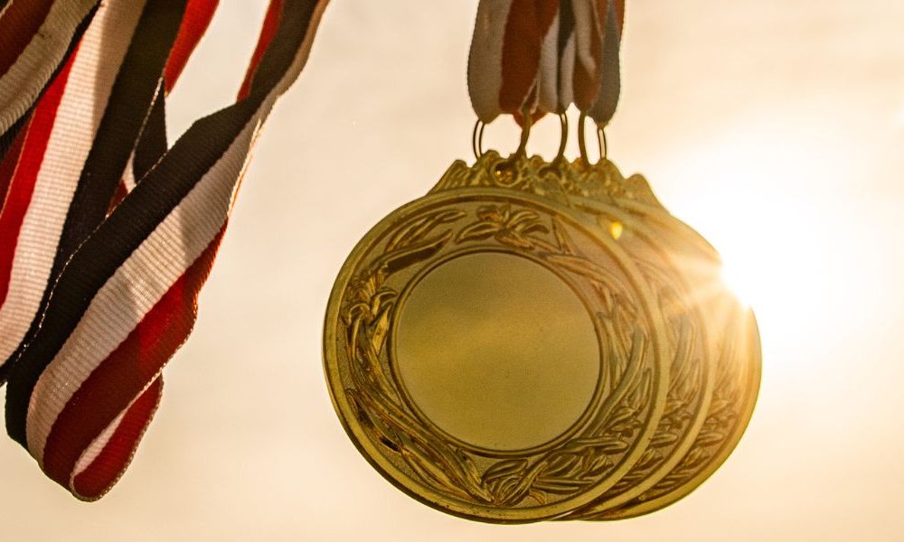 Gold medals in front of the sun.