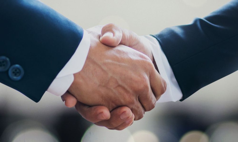 Two business people shaking hands.