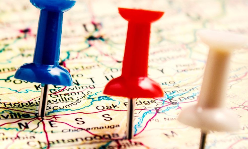 A line of thumb tacks stuck on a map.