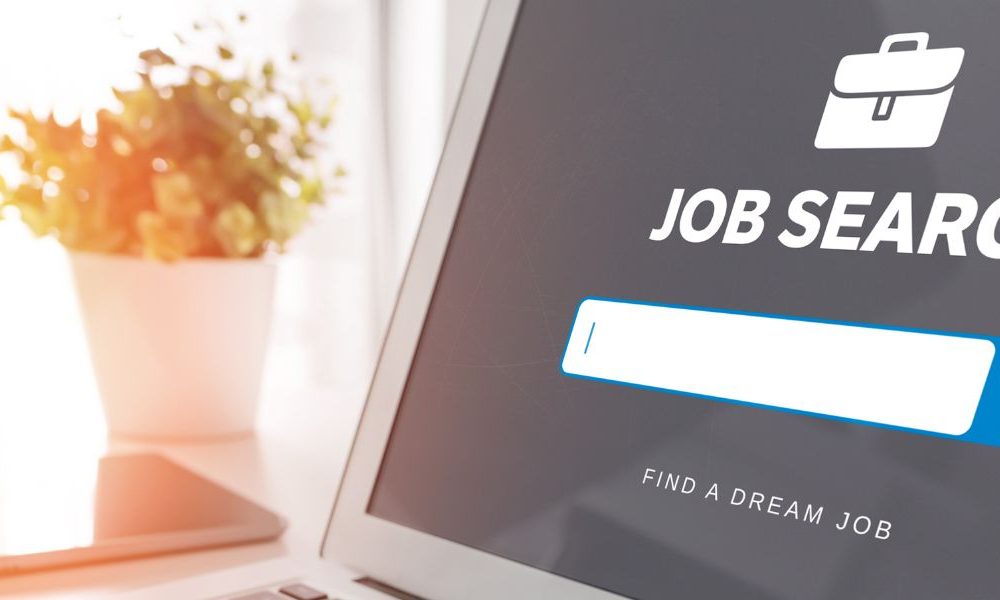 An open laptop that says "Job Search" on the screen.