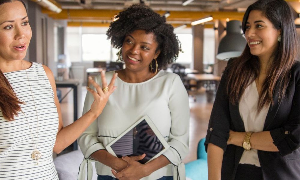Women talking in an office.