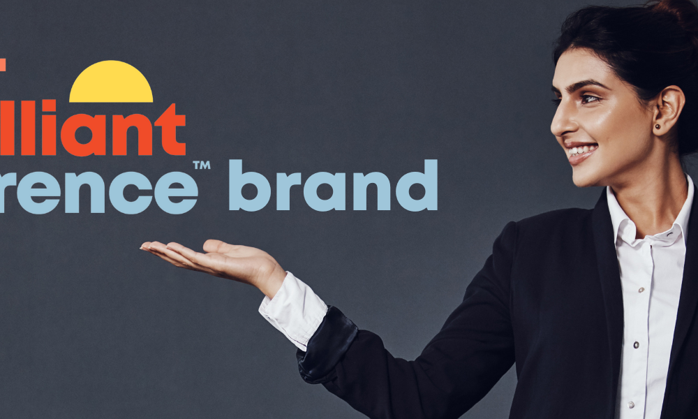 A woman holding up a logo that says Your Brilliant Difference Brand.