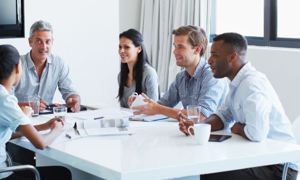 People sitting around a table in a meeting room.
