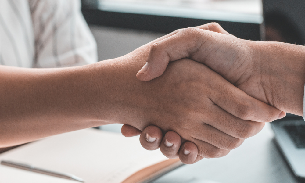 Two people shaking hands.